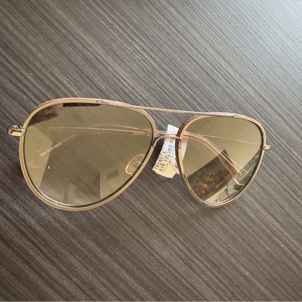 Jimmy Choo Triny /S Aviator with a silver frame and pink glitter details.
